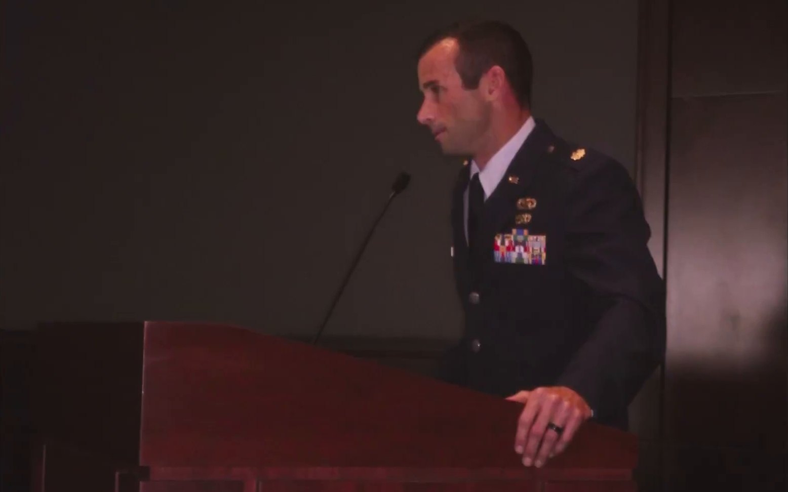 Ken Corigliano speaking at a podium in Air Force service dress